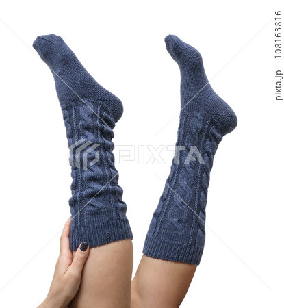 Female legs in dark blue hand knitted wool knee socks Female legs in dark blue hand knitted wool knee socks 108163816