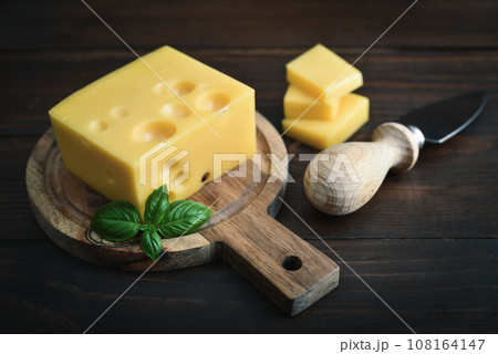 Cheese with holes large and small 108164147