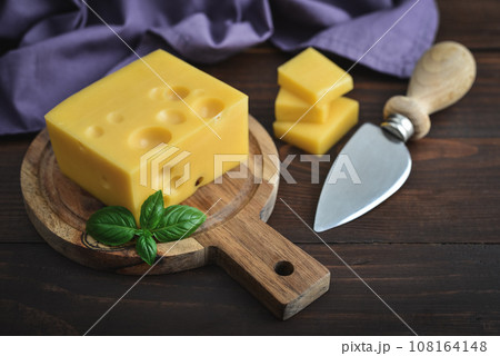 Cheese with holes large and small 108164148