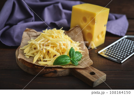 Grated cheese  on a cutting  board 108164150