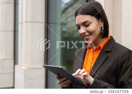 Elegant young manager with a tablet in the office area 108167356