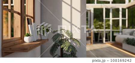 A wooden wall shelf against the window in a modern bright spacious living room. close-up image A wooden wall shelf against the window in a modern bright spacious living room. close-up image 108169242