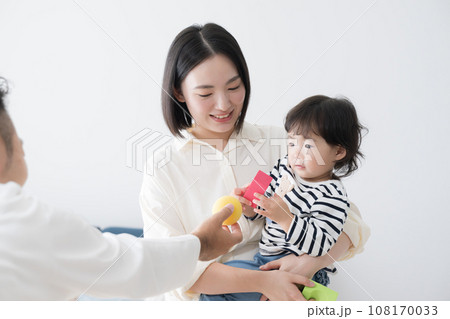 子どもにおもちゃを渡す休日の父親 108170033