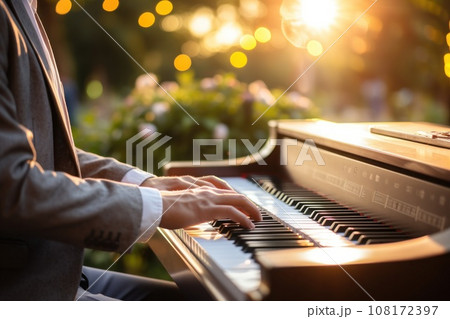 Photo of male hands of a person playing the piano bokeh lights in the background. Generative AI 108172397