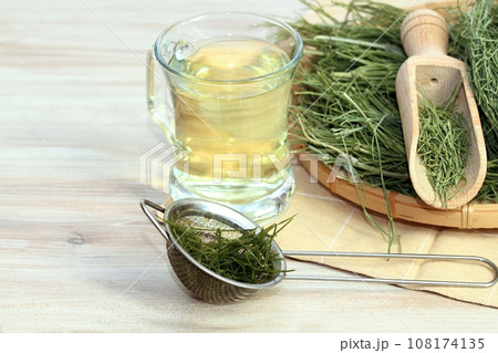 Herbal tea from Equisetum arvense, the field horsetail or common horsetail, dried herb in the basket. Herbal tea from Equisetum arvense, the field horsetail or common horsetail, dried herb in the basket. 108174135