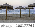 Natural beach umbrellas, on a empty beach in the Mediterranean, in the early evening	 108177765