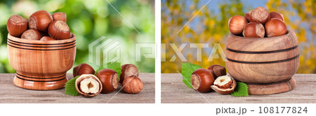 Hazelnuts with leaves in a wooden bowl on a wooden table with blurred garden background 108177824