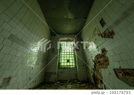 From above view of narrow room with shabby walls broken ceramic tiles and glass window with fence rubbish trash on uncleaned floor in uninhabited building in daylight From above view of narrow room with shabby walls broken ceramic tiles and glass window with fence rubbish trash on uncleaned floor in uninhabited building in daylight 108178783
