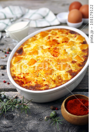 French cuisine. Vegetable pumpkin clafoutis in ceramic bakeware, smoked paprika dressing, eggs and cream French cuisine. Vegetable pumpkin clafoutis in ceramic bakeware, smoked paprika dressing, eggs and cream 108179122