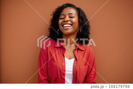 Portrait of African American happy smiling woman wearing red t-shirt on orange background. Copy space. Ai generation. Concept of advertising, psychology and business 108179798
