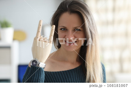 Smiling woman with prosthetic arm 108181007