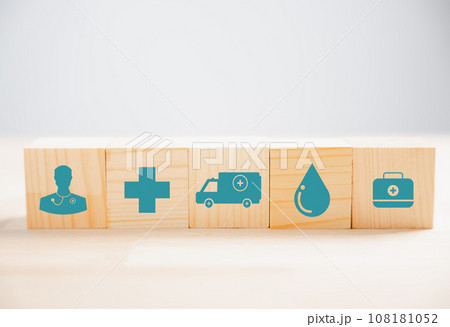 Medical icon crowns a pyramid stack of wooden cube blocks, representing healthcare and insurance concepts. white background offers copy space for vaccination, health, and medical technology. 108181052