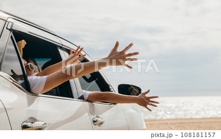 Close up of hands. Happy family sitting in the car waving hands travel outside car windows going to beach for travel, People having fun outdoors on road trip, vacation holiday 108181157