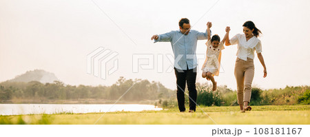 A group of cheerful people walking and having fun together in a beautiful nature setting on a sunny day, feeling the beauty and the energy of the outdoors, Happy family day 108181167