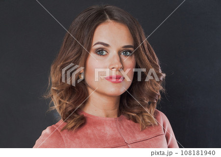 Beautiful young adult woman with clear perfect skin, makeup and wavy brown hair. Beauty lady  108181940