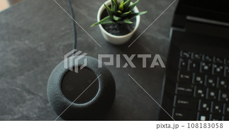 HomePod Mini speaker with assistant to play music, static on desk. Concept of a smart home. HomePod Mini speaker with assistant to play music, static on desk. Concept of a smart home. 108183058