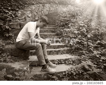 Sad man sitting on the stairs Sad man sitting on the stairs 108183605