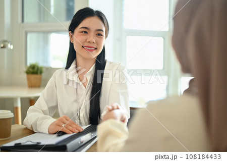 Beautiful businesswoman shaking hands with business partners after negotiate in office Beautiful businesswoman shaking hands with business partners after negotiate in office 108184433