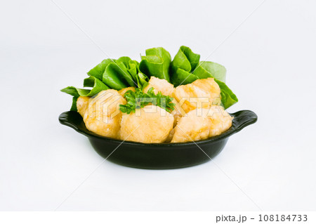 Breaded Chicken Inner Fillet with green lettuce leaves on a White Background,Chicken Breaded Raw Meat,Fillet.Breaded chicken nuggets. Fast homemade food at home.Chicken breaded schnitzels.Fast cooking 108184733