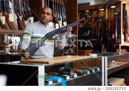 Owner of armory shop offering hunting pump action shotgun 108185753