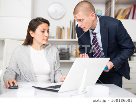 Businessman and business woman working together at office 108186083