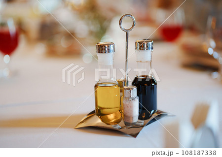 Set of containers for spices, oil and vinegar on a metal stand Set of containers for spices, oil and vinegar on a metal stand 108187338