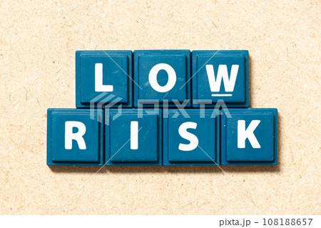 Tile alphabet letter in word low risk on wood background Tile alphabet letter in word low risk on wood background 108188657