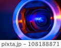 Video camera lens lit by blue and red neon light 108188871