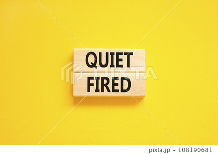 Quiet fired symbol. Concept words Quiet fired on wooden blocks. Beautiful yellow table yellow background. Business and quiet fired concept. Copy space. 108190681
