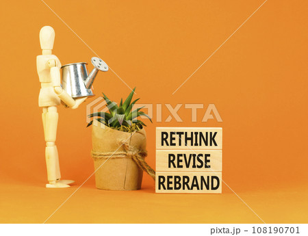 Rethink revise rebrand symbol. Concept word Rethink Revise Rebrand on beautiful block. Beautiful orange table orange background. Business brand motivational rethink revise rebrand concept. Copy space. 108190701