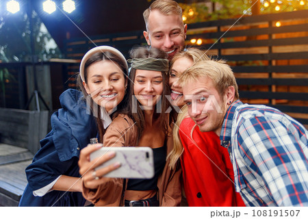 Happy four friends watching internet social media in cell phone. Every one with his own phone 108191507