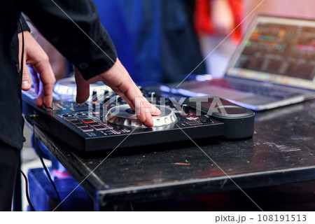 Close up of hands spinning the decks at the nightclub 108191513