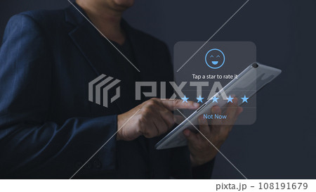 a businessman using application on tablet the virtual screen to give satisfaction in service.rating star very impressed.Customer service and Satisfaction concept. 108191679