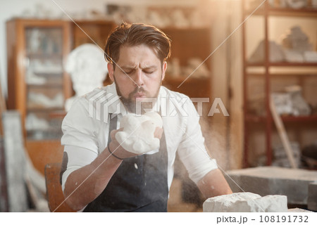 Craftsman hands working with stone sculptor at creative workplace in the atmospheric studio. 108191732