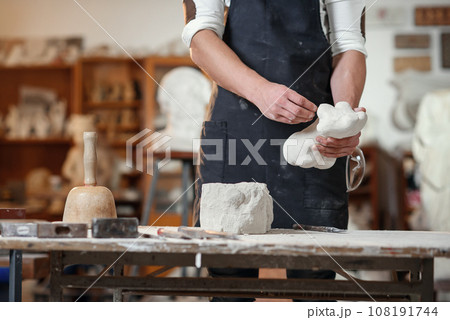 Craftsman hands working with stone sculptor at creative workplace in the atmospheric studio. Craftsman hands working with stone sculptor at creative workplace in the atmospheric studio. 108191744