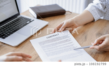 Businesswoman lawyer pointing into contract special points admitting something for colleague or client at the wooden desk in office. Business people teamwork and partnership, meeting concept Businesswoman lawyer pointing into contract special points admitting something for colleague or client at the wooden desk in office. Business people teamwork and partnership, meeting concept 108192799