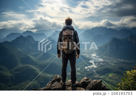 Traveler standing on top of a mountain 108193703