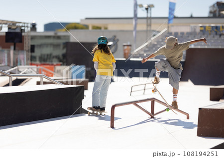 Skater preparing for a trick, bending low Skater preparing for a trick, bending low 108194251