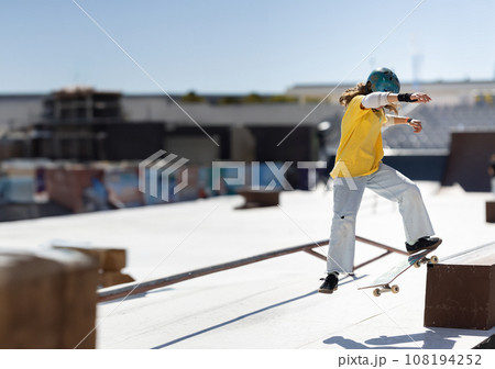 Skater young teen girl cruising on a flat platform 108194252