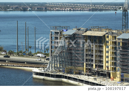 Aerial view of ruined by hurricane Ian construction scaffolding on high apartment building site in Port Charlotte, USA 108197017