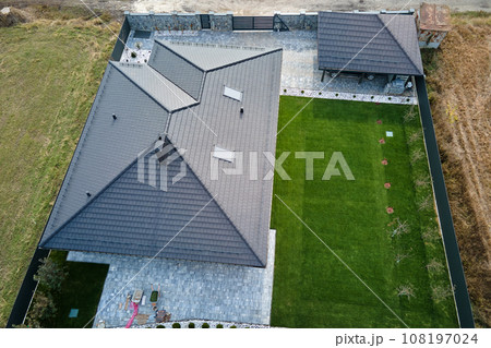 Aerial view of residential house with backyard in suburban rural area Aerial view of residential house with backyard in suburban rural area 108197024