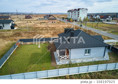 Aerial view of residential house with backyard in suburban rural area Aerial view of residential house with backyard in suburban rural area 108197025