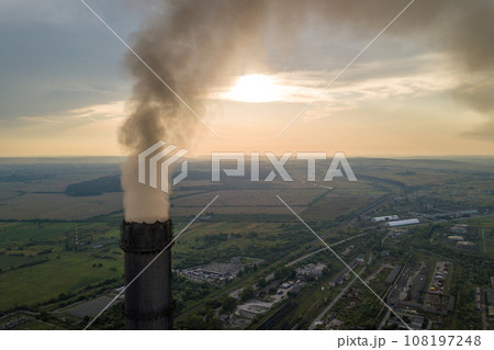 Aerial view of high chimney pipes with grey smoke from coal power plant. Production of electricity with fossil fuel. 108197248
