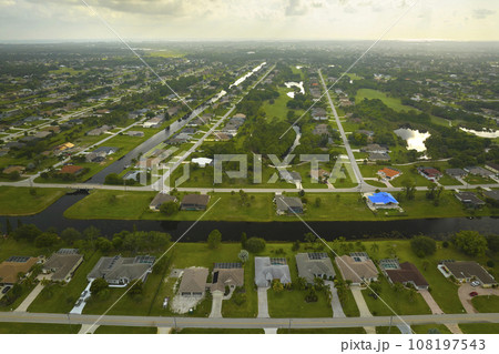 Aerial landscape view of suburban private houses between green palm trees in Florida quiet rural area 108197543
