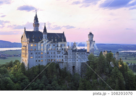 Aerial view of Neuschwanstein Castle with teenager hiking girl on the foreground Aerial view of Neuschwanstein Castle with teenager hiking girl on the foreground 108201070