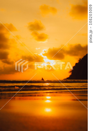 Layan Beach, Phuket, Thailand,Silhouette Two Asians standing fishing at the sea as the sun sets, 108203009