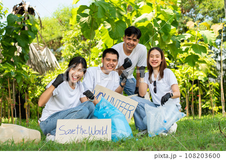 Happy young Asian students diverse volunteers hold a campaign sign for cleaning in the park, The concept of environmental conservation on world environment day, recycling, charity for sustainability. 108203600