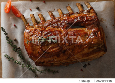 Delicious roasted ribs served on wooden table, flat lay 108204440