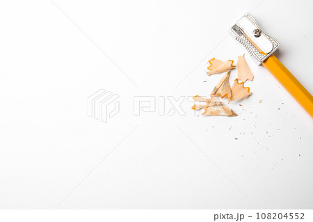 Graphite pencil, shavings and sharpener on white background, top view. Space for text 108204552