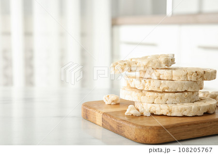 Puffed rice cakes on white marble table indoors. Space for text Puffed rice cakes on white marble table indoors. Space for text 108205767